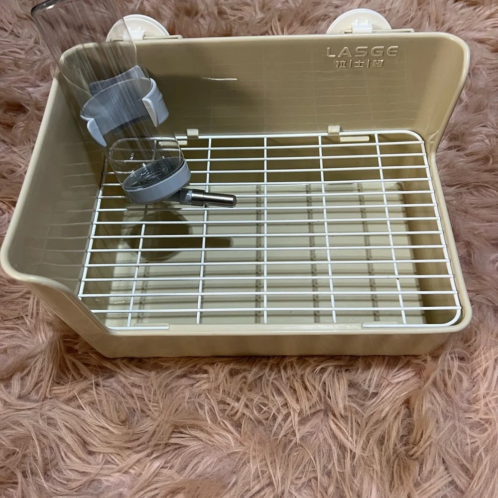 Small pets litter box and water bottle.